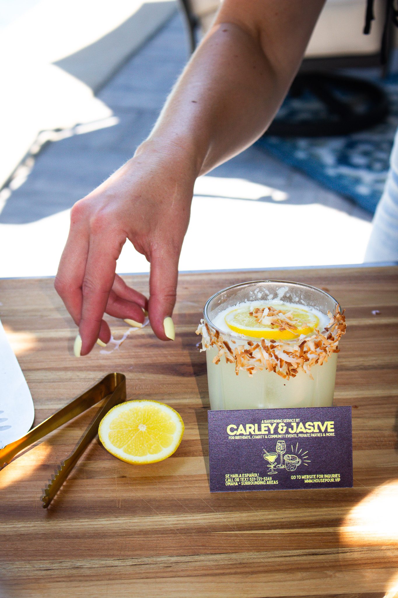A House Pour cocktail beside Carley and Jasive’s branded card