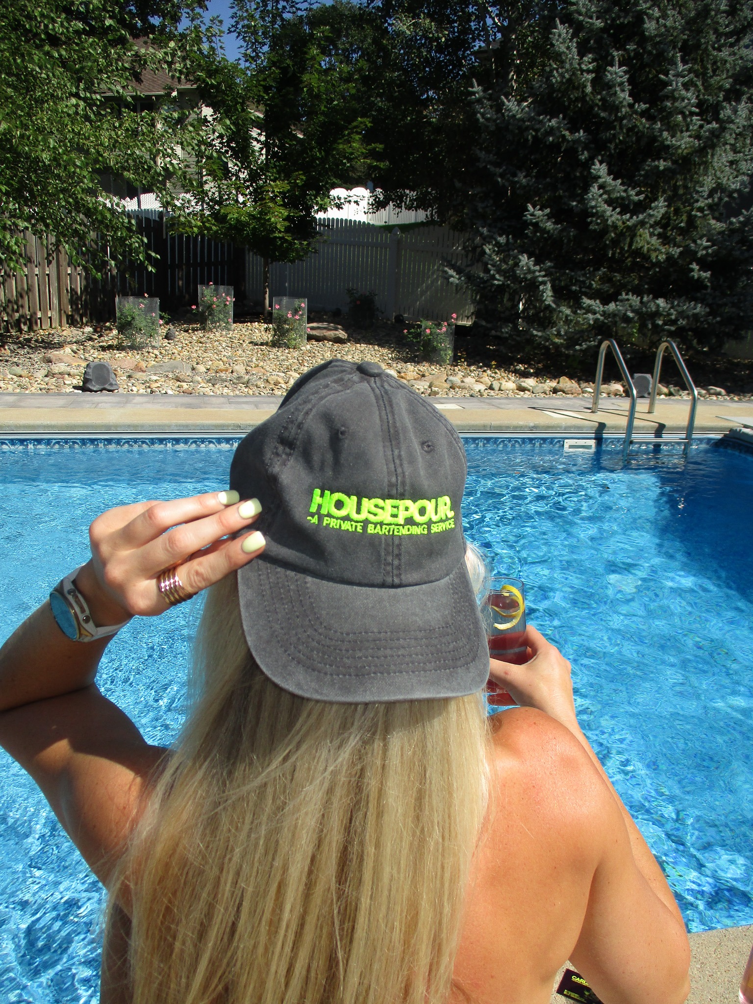 A House Pour hat worn poolside